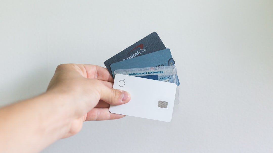 Person holding a credit card, representing credit card debt settlement